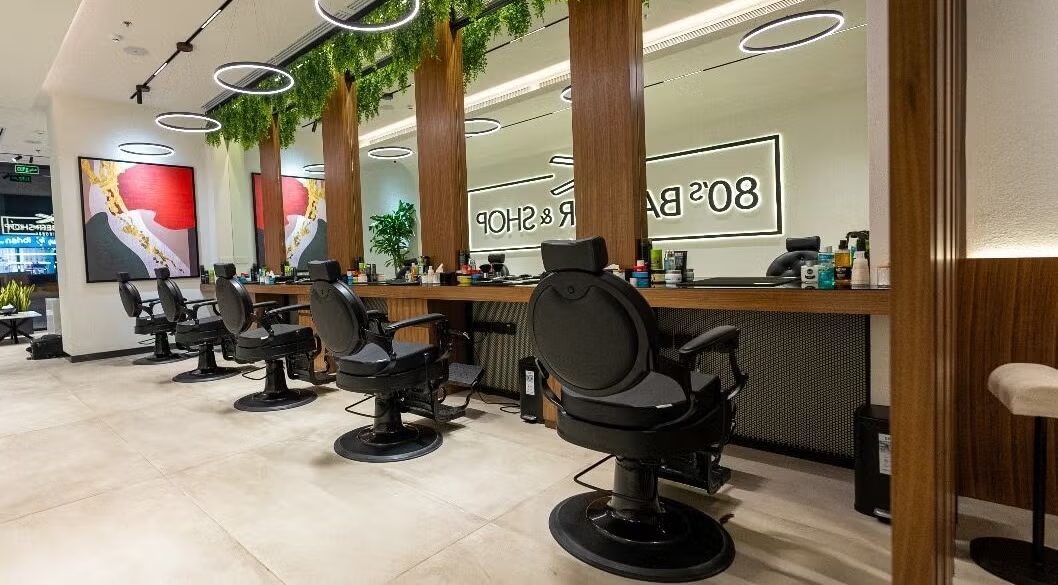 Barber stations with walnut columns and ring lights